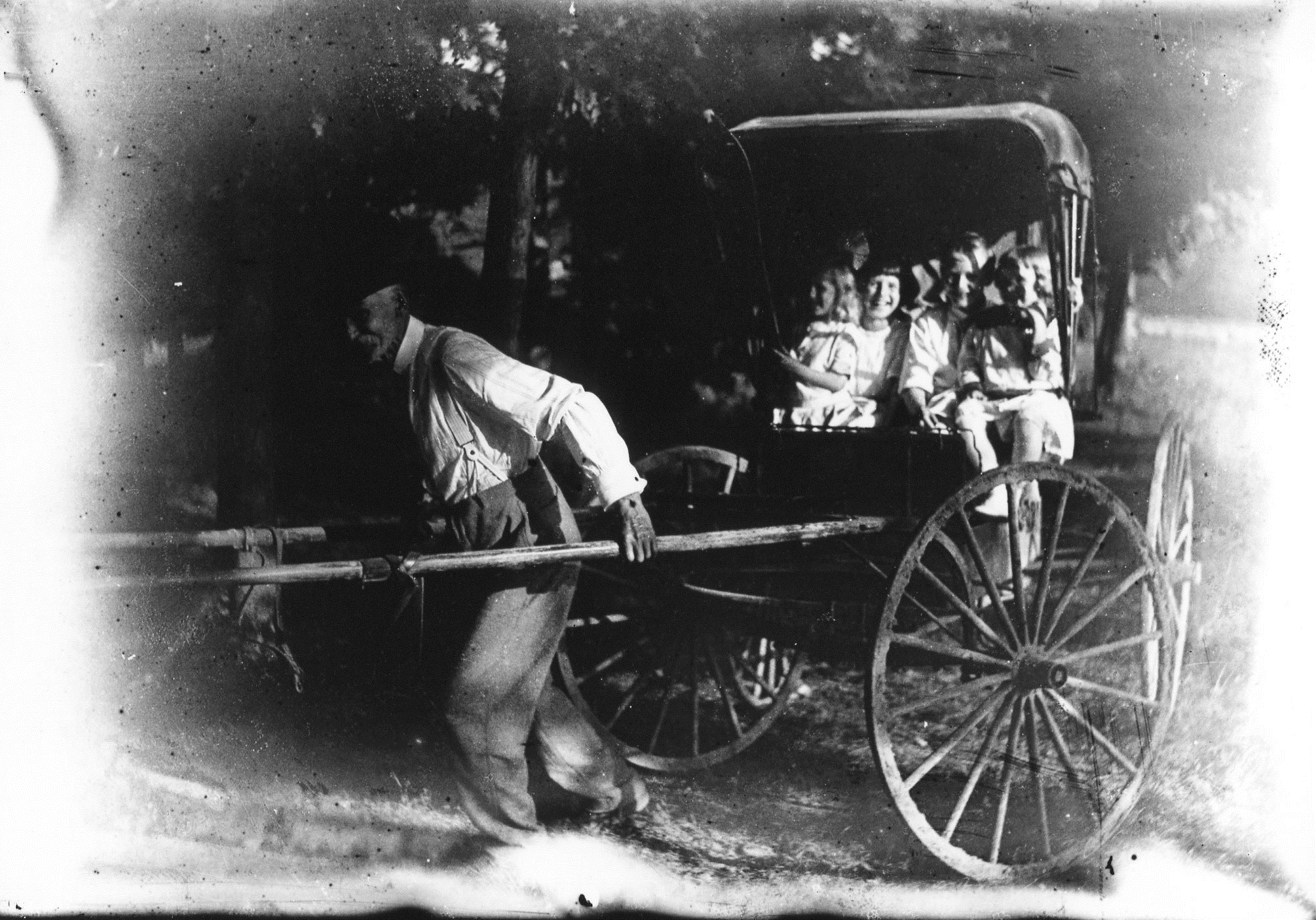 photo of Older Man Pulling a Buggy