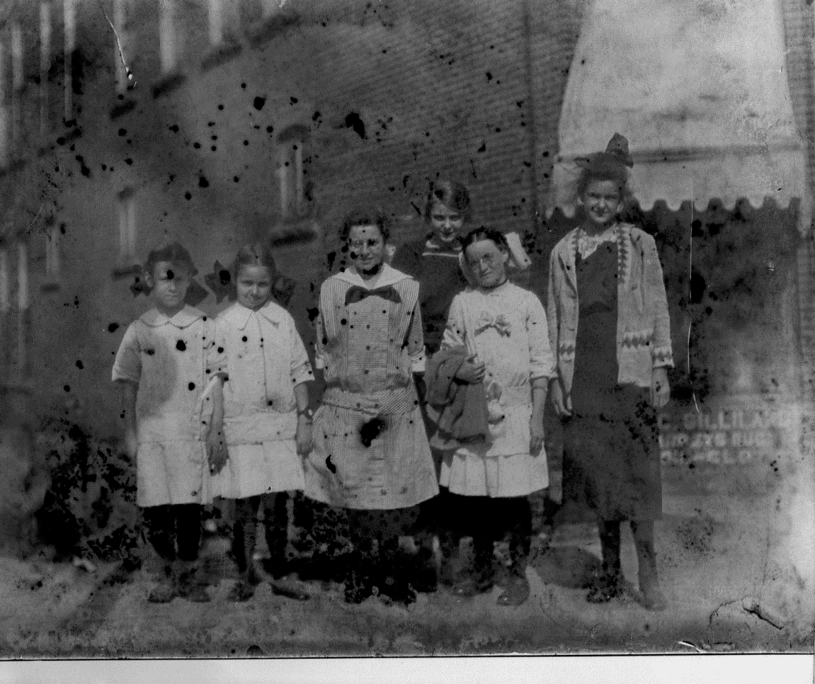 photo of Unidentified Women Standing in Front of Building