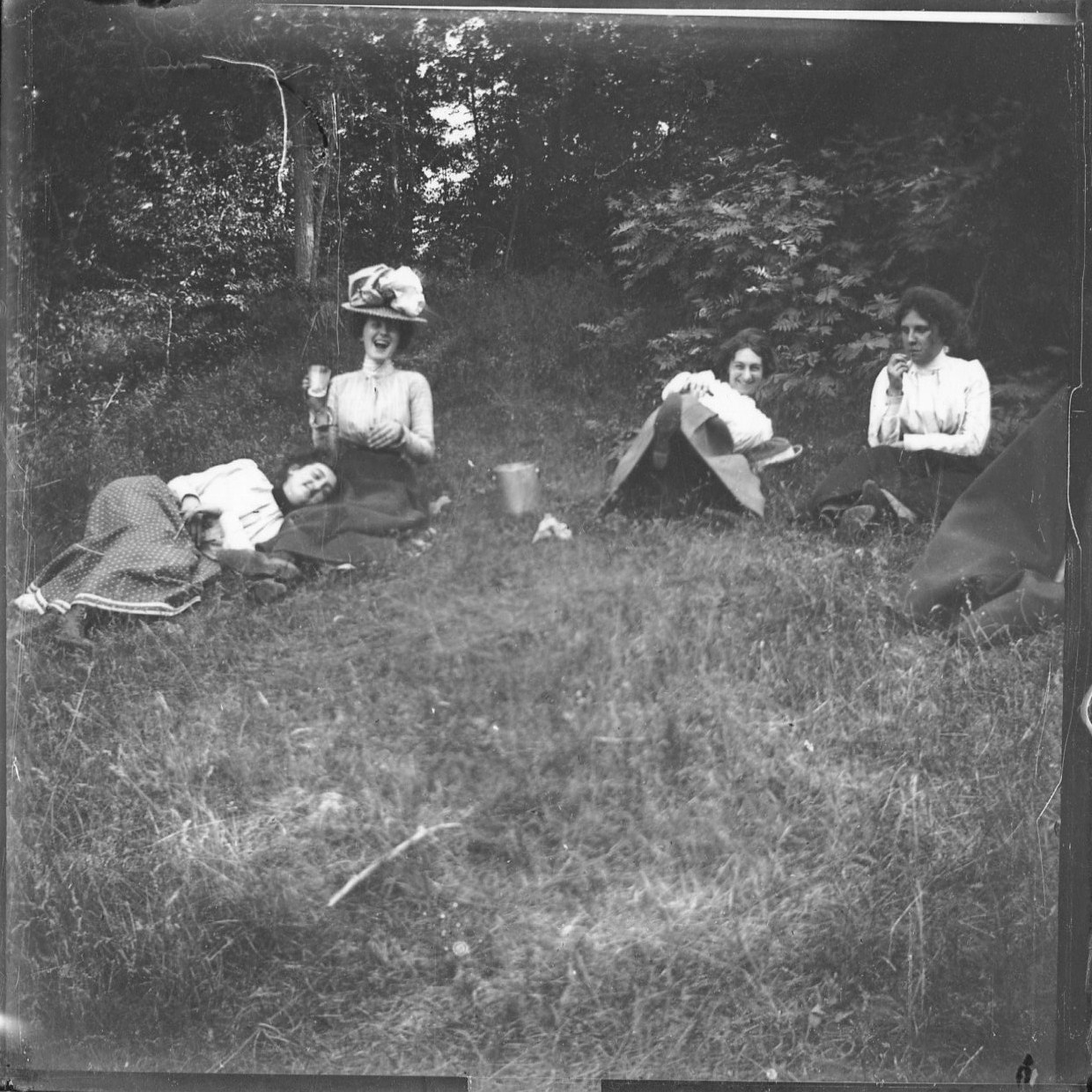 photo of Four Unidentified Women Sitting in a Field