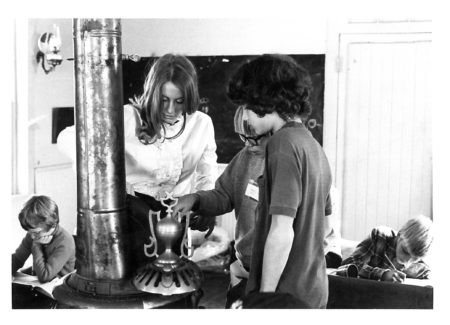 photo of Teacher with Students in School House