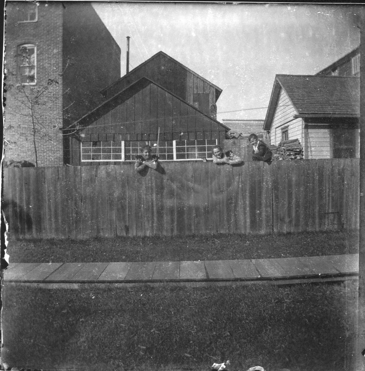 photo of Three Unidentified People Behind Fence