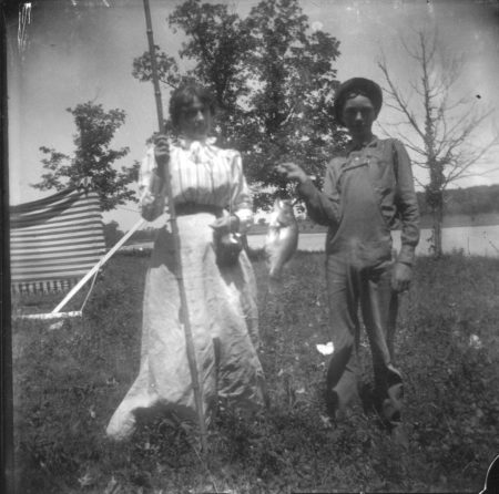 photo of Two Unidentified Children with a Fish and Pole