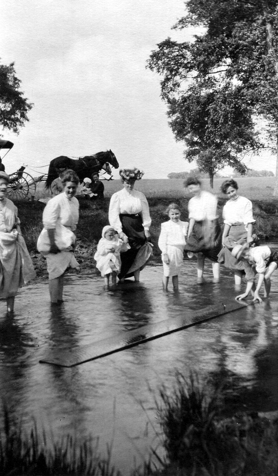photo of Unidentified Women and Children Wading in a Stream