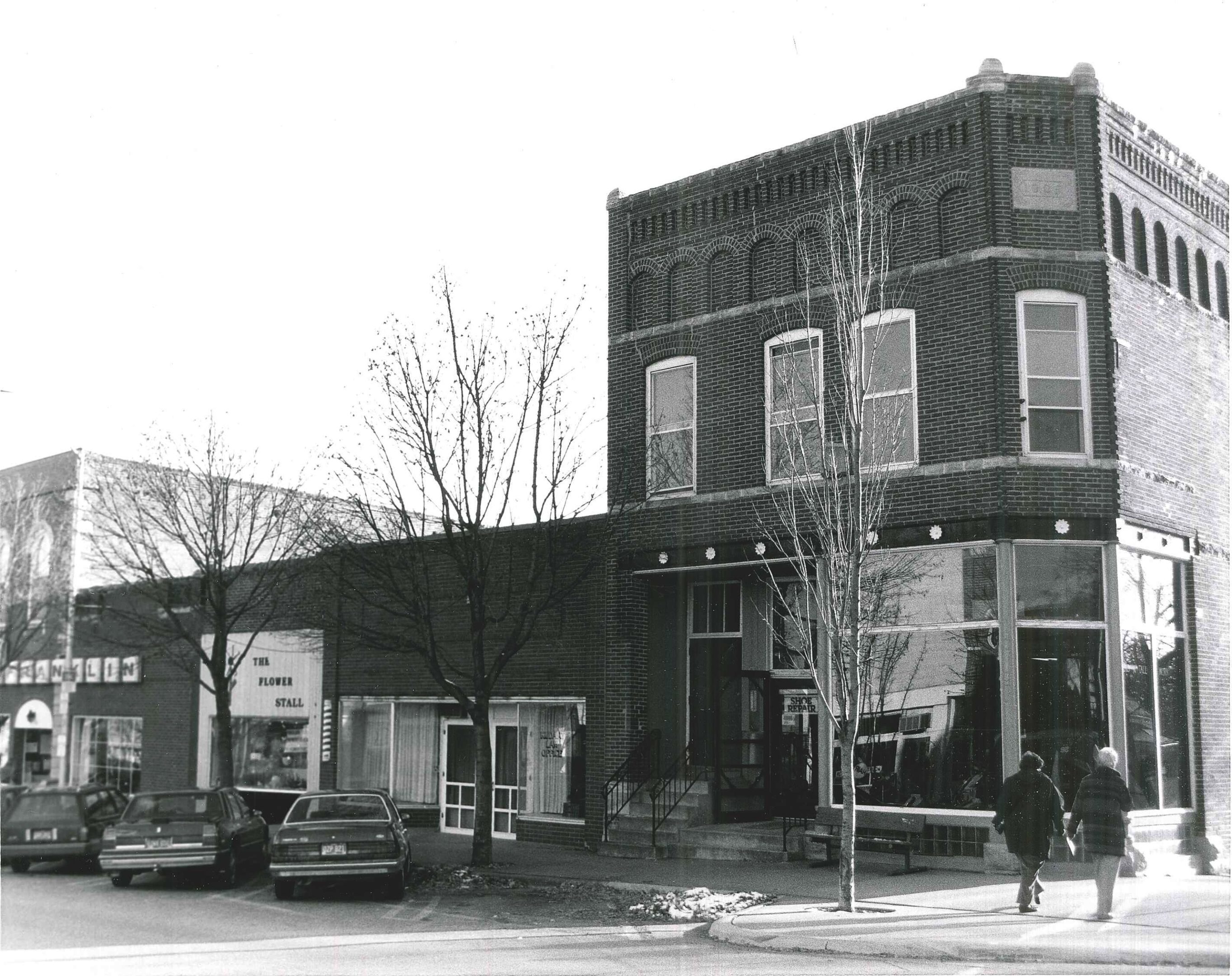 Photo of buildings on South side of First Street W. Photographed 1990 by Barbara Beving Long.