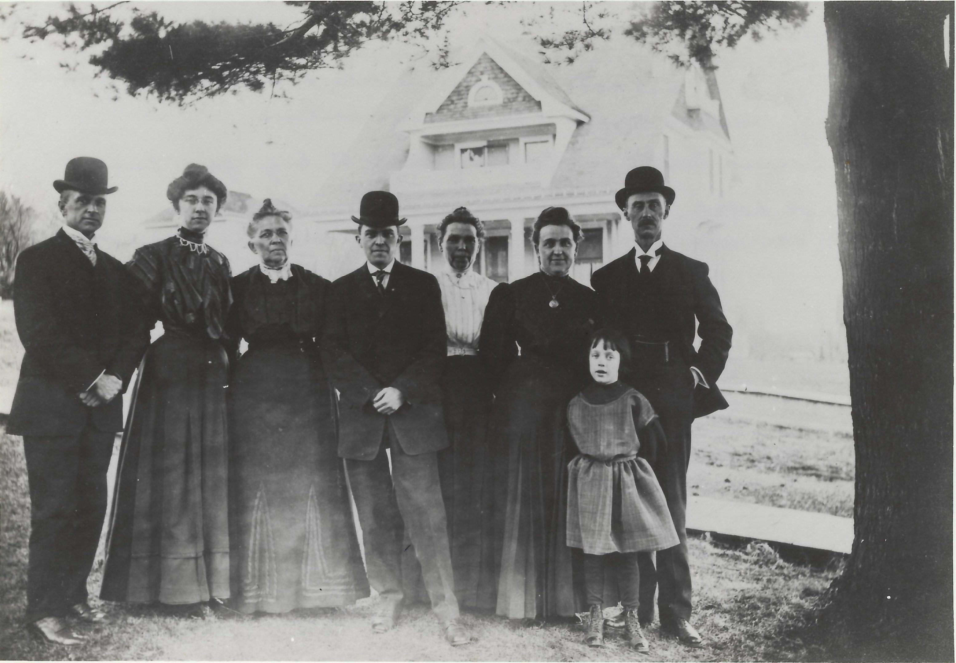Photo of Keyes family standing next to big pine tree