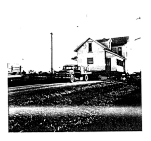 Photo of a truck moving a house