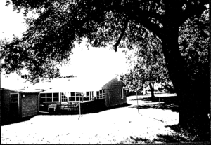 Back porch of the Mount Vernon Motel. It is an enclosed patio with two chairso