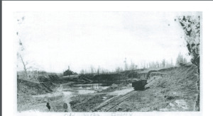 Picture of the Old Verba Quarry. It is a flattened, excavated landscape with a railroad track going around the edge.