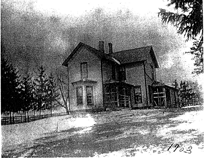 Black and white photo of a farmhouse built in the traditional American style in the 19th century