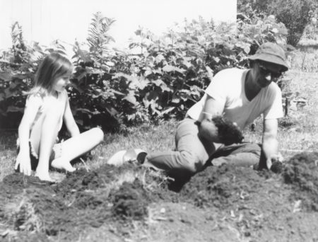 Photo of Kirsten Sutherland learns to garden from her grandfather, Robert W. Sutherland. 1974