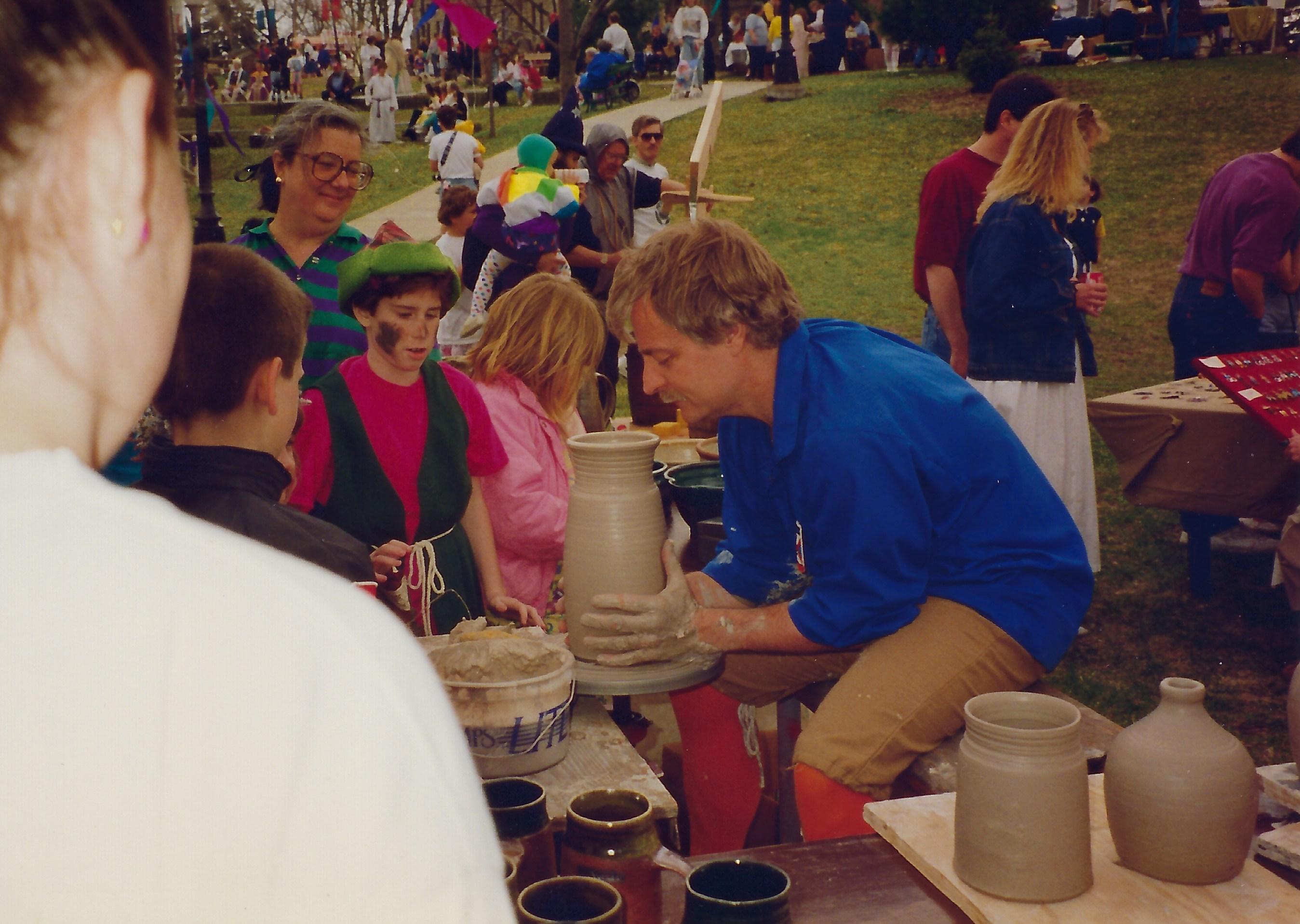 Photo of Hansen demonstrating throwing pottery on the wheel
