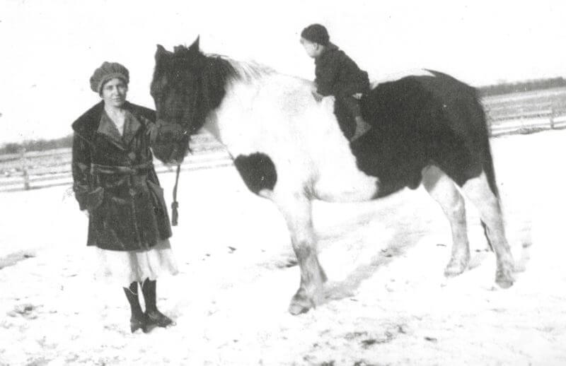 Photo of a mother leading a pony