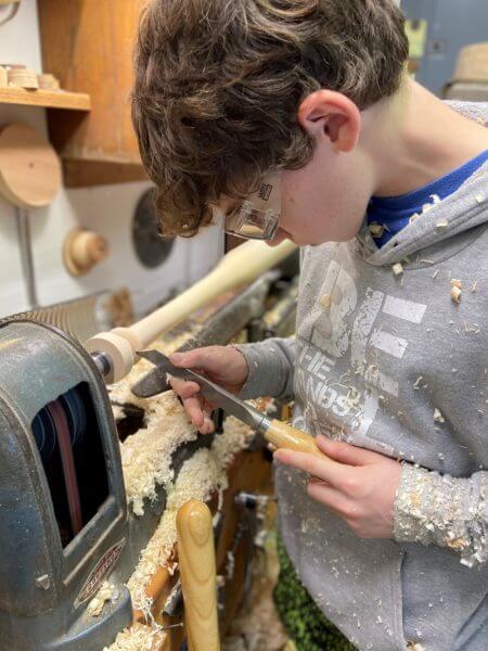 Photo of Tommy Rhomberg using his woodworking lathe