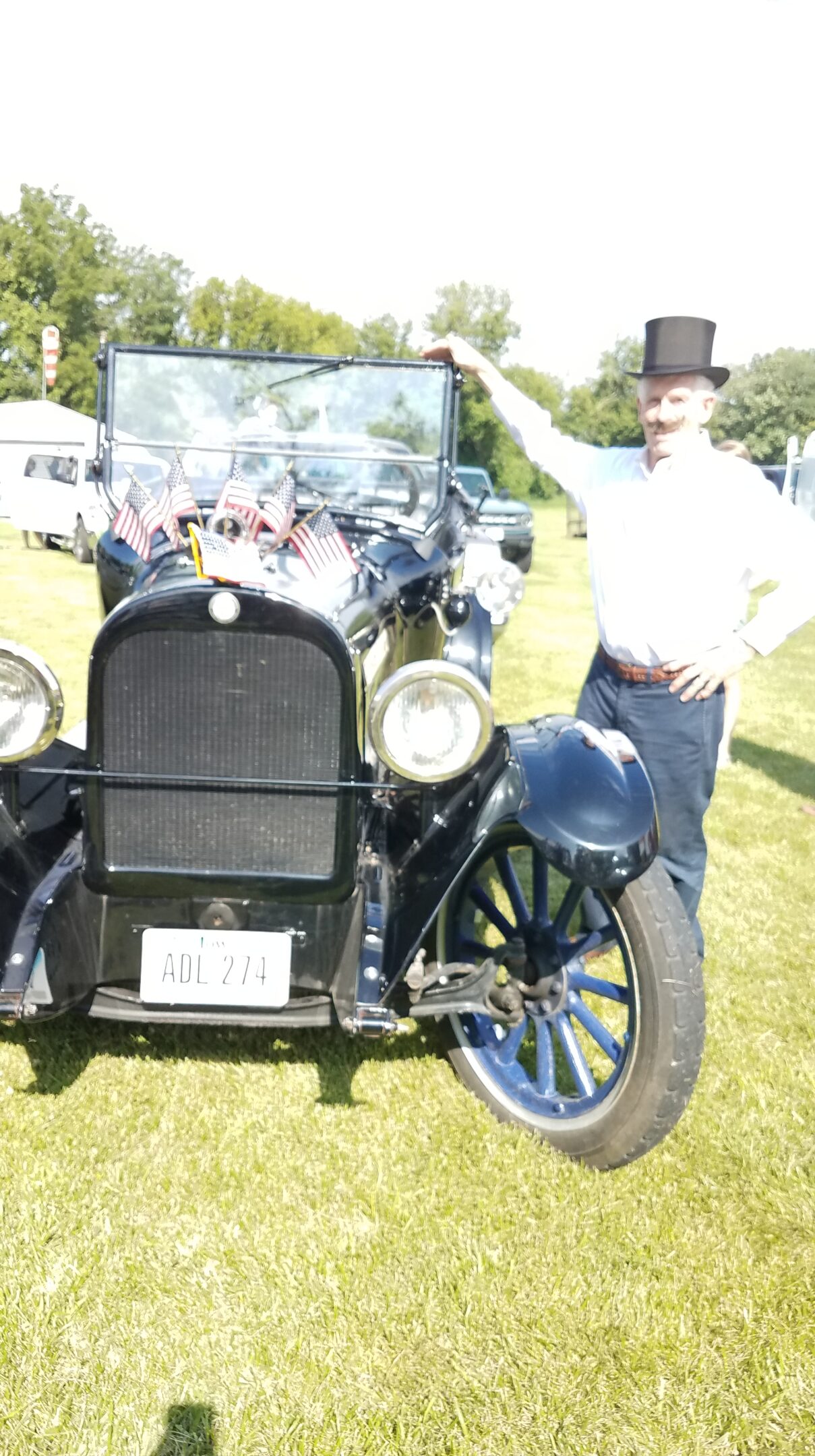 Photo of Guy Booth standing beside 1923 Dodge Brothers car
