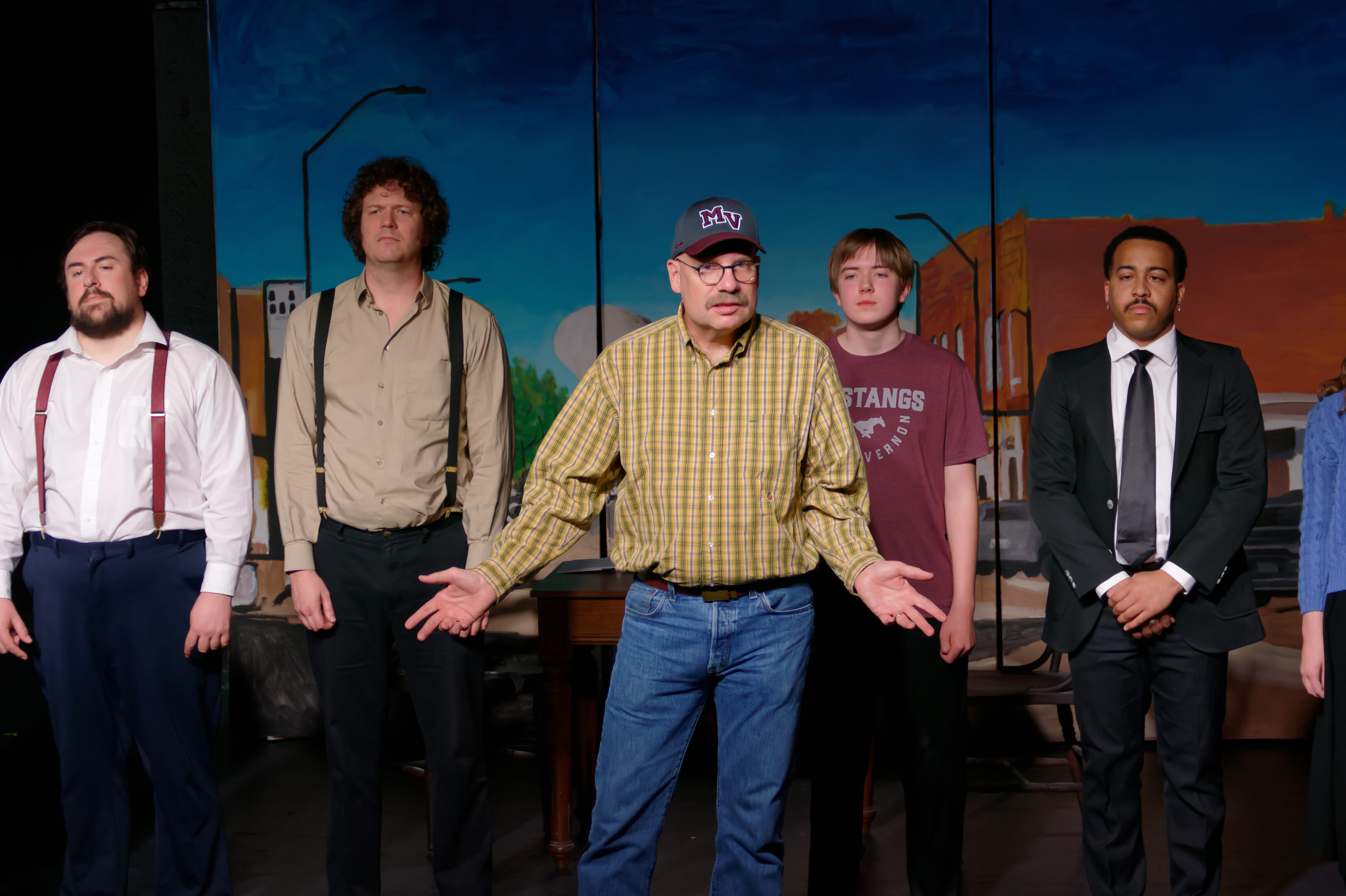 2023-Treasure Play-Chris Childers as narrator Zeke speaks in front of actors Trevor Baty, Dennis Rodenberg, Chester Rood, and Deon Nelson