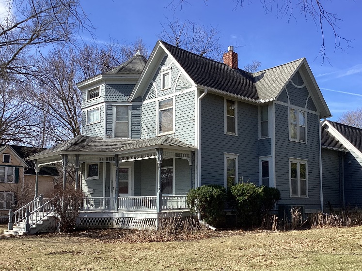 2-story wooden home with blue siding and white trim.  Example of The Stick style