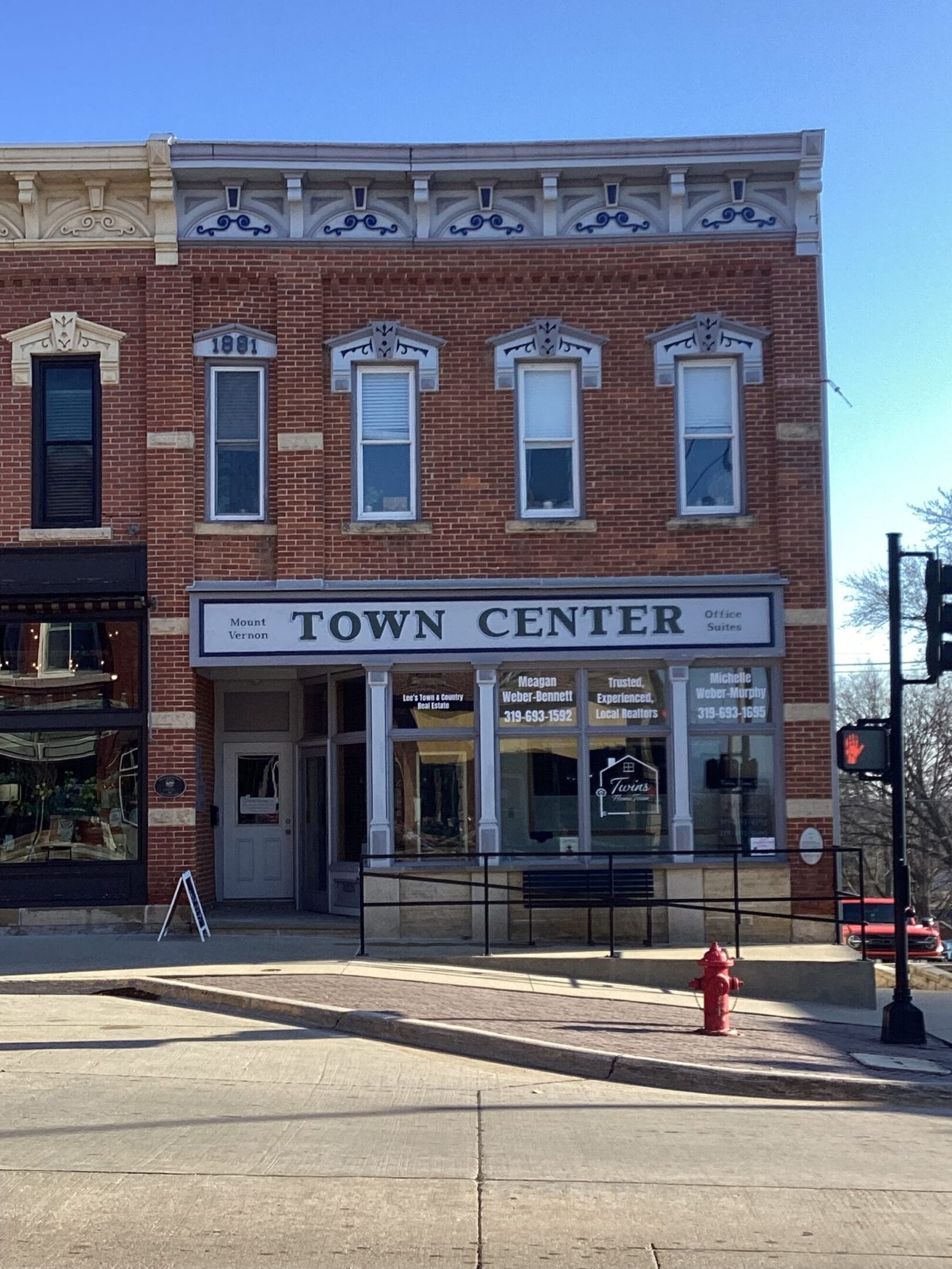 2-story brick building with large display windows on the first floor and tall thin windows on the second floor.  The building also has a large sign that says "Town Center"