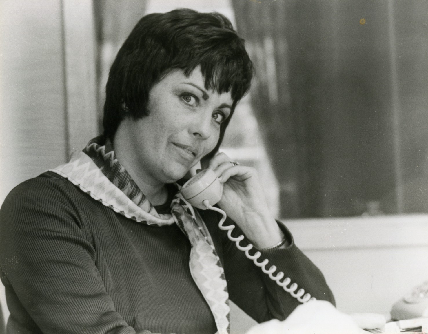 Photo of Carol Walden talking on the telephone.