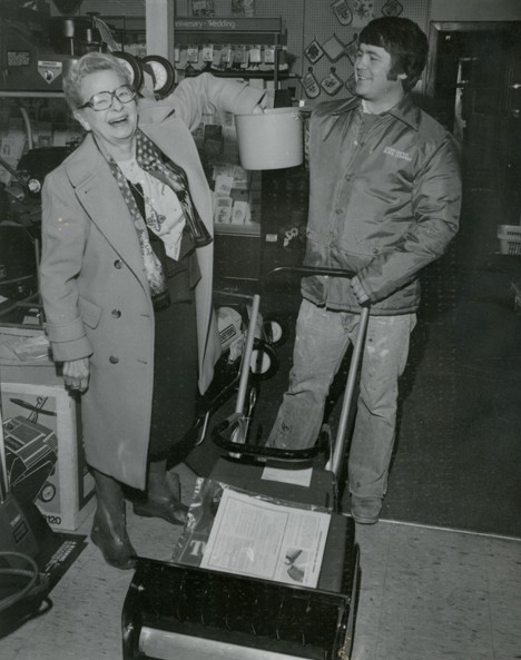 Black and white photo of Doris Pringle drawing the winning ticket for the Jaycee raffle.