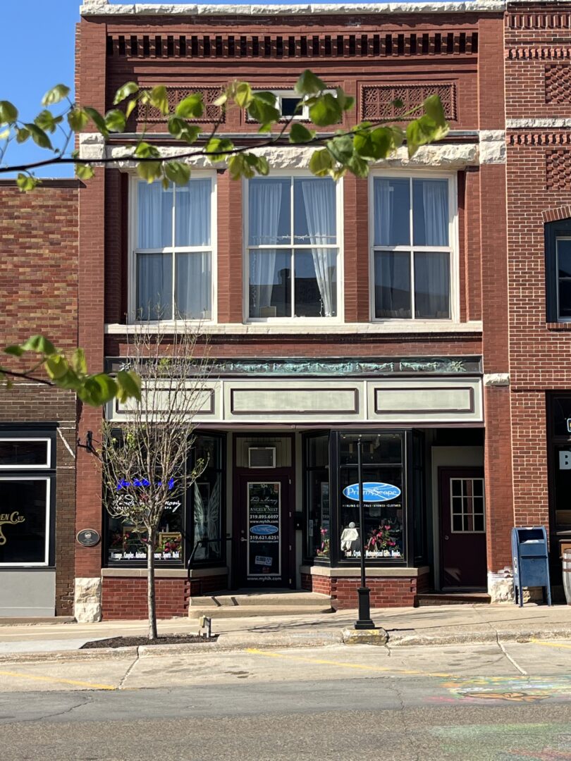 A red brick building housing a day spa called Hands in Harmony.