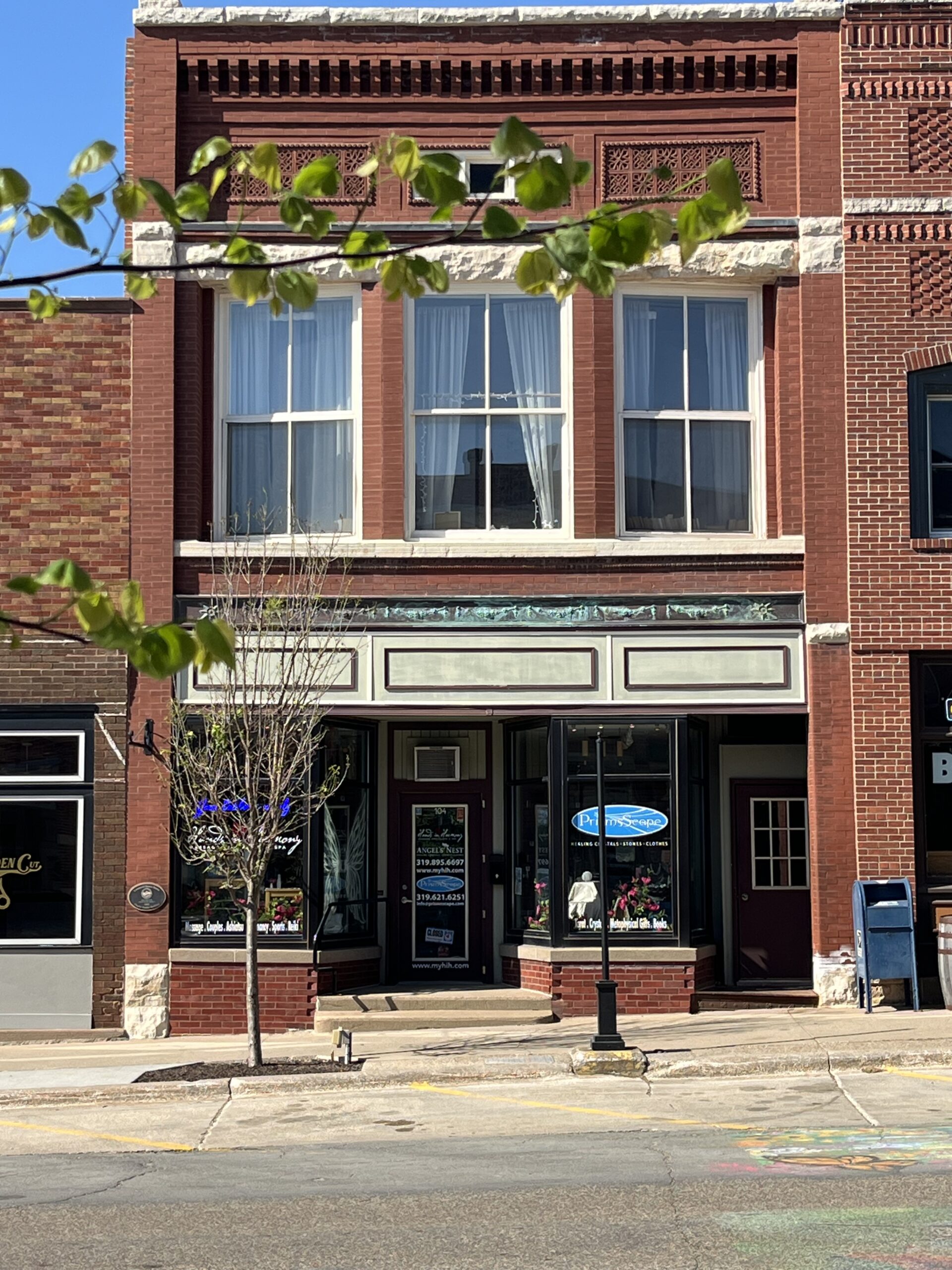 A red brick building housing a day spa called Hands in Harmony.