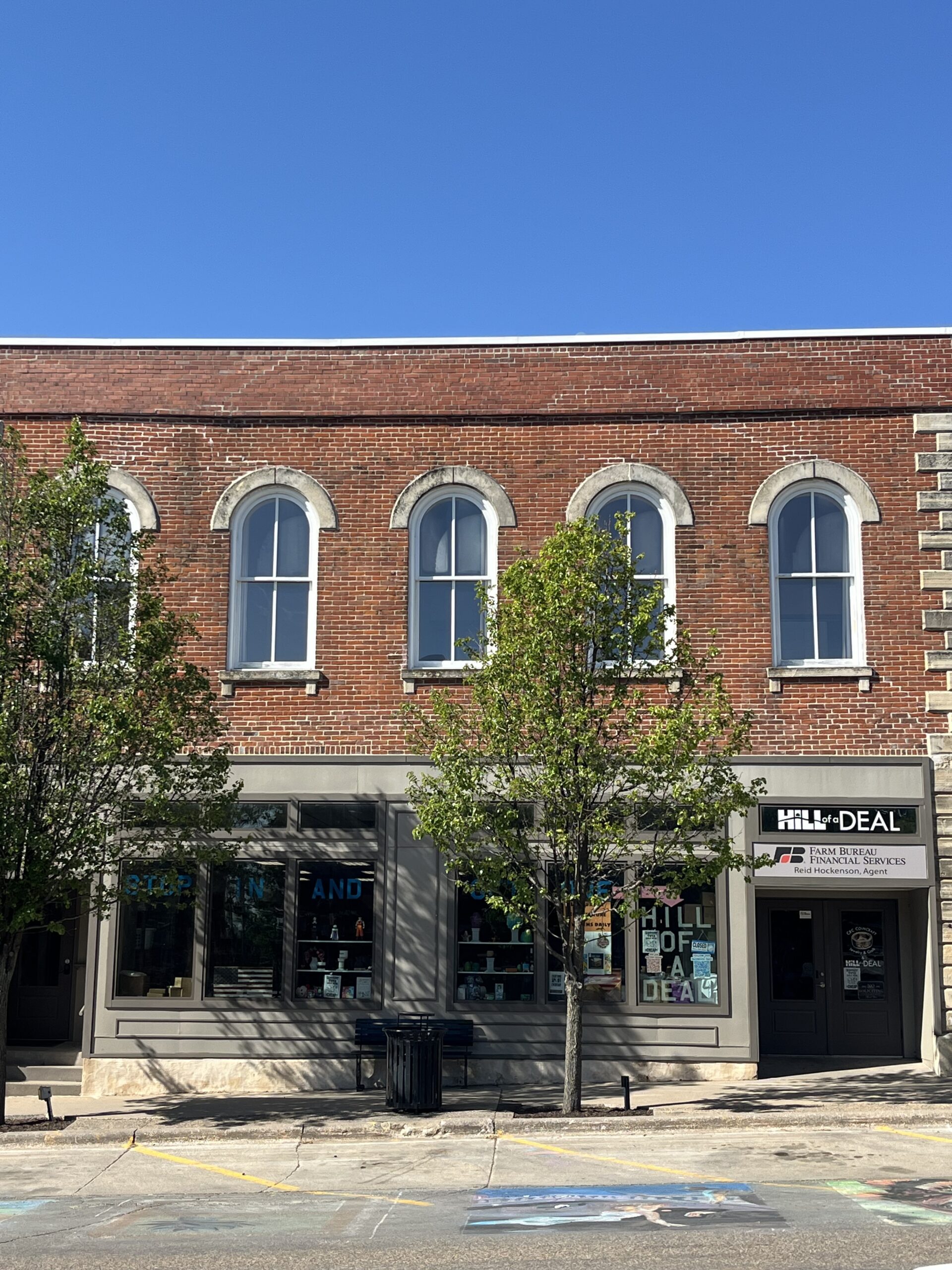 Photo of red brick building with arched upper story windows housing Hill of a Deal.