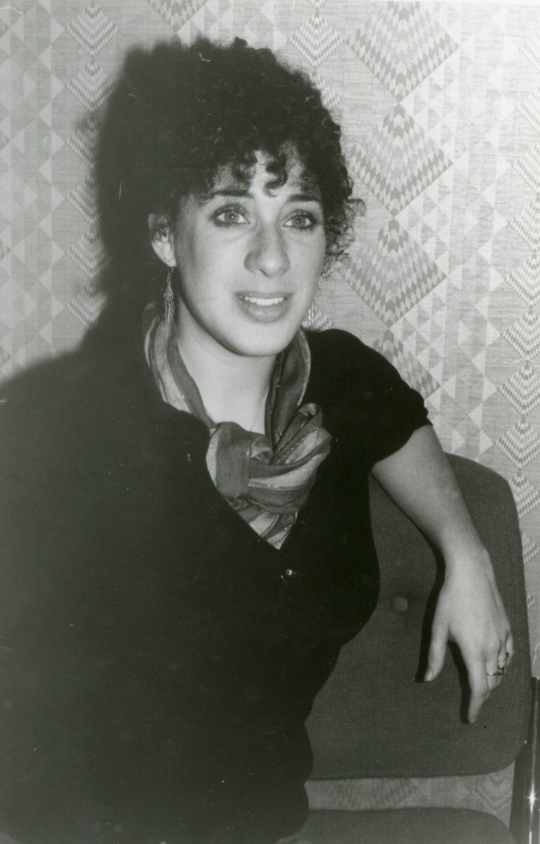 Photo of Jennifer Bern sitting with arm draped over back of the chair.