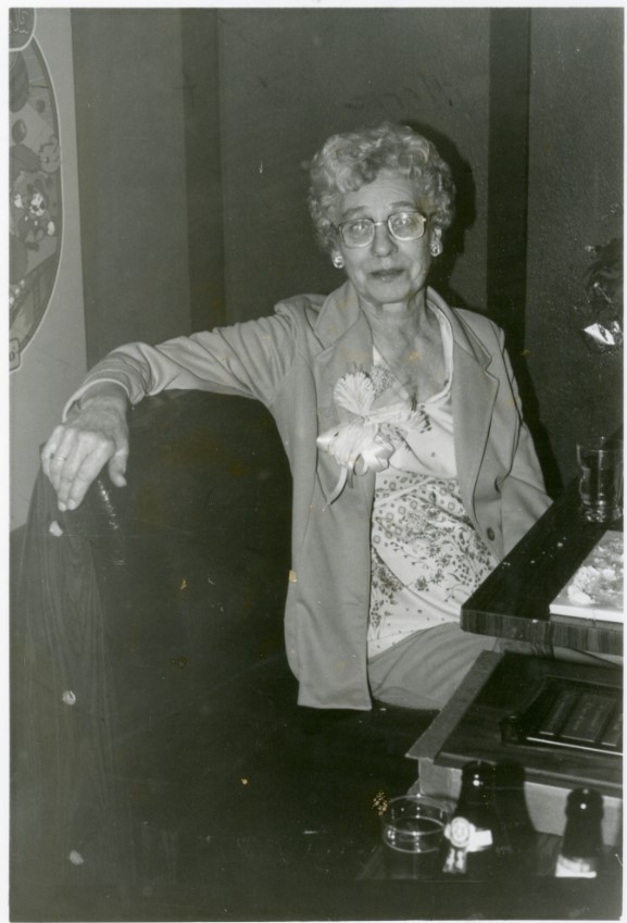 Black and white photo of Marie Studt sitting at a desk.
