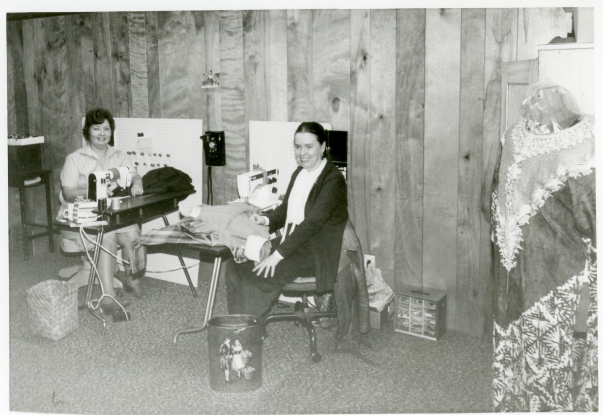 Black and white photo of Pat Coon and Betty Budack, employees at Pinhook Tailoring, sitting at their sewing machines.