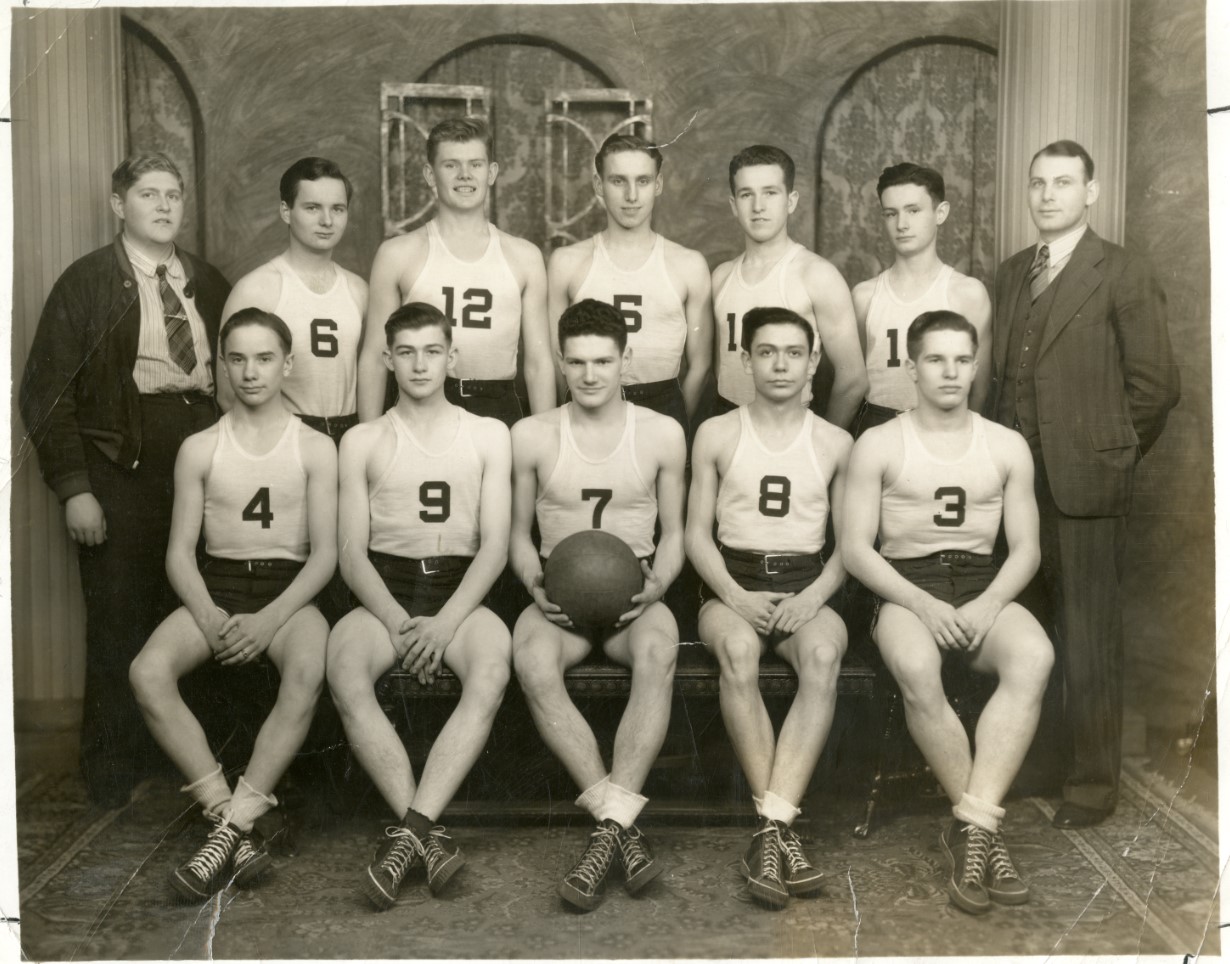 Black and white team photo of members of the 1939 MVHS Boys Basketball team posing for a photo in two rows.