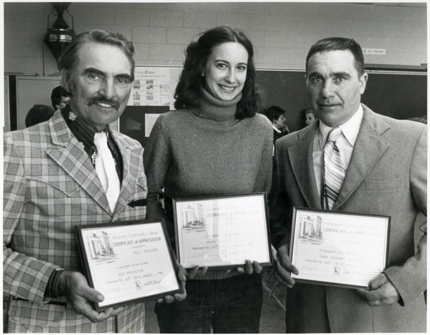 Black and white photo of Milo Wolrab, Anne Duffy, and Roland Henik holding certificates from Kirkwood.