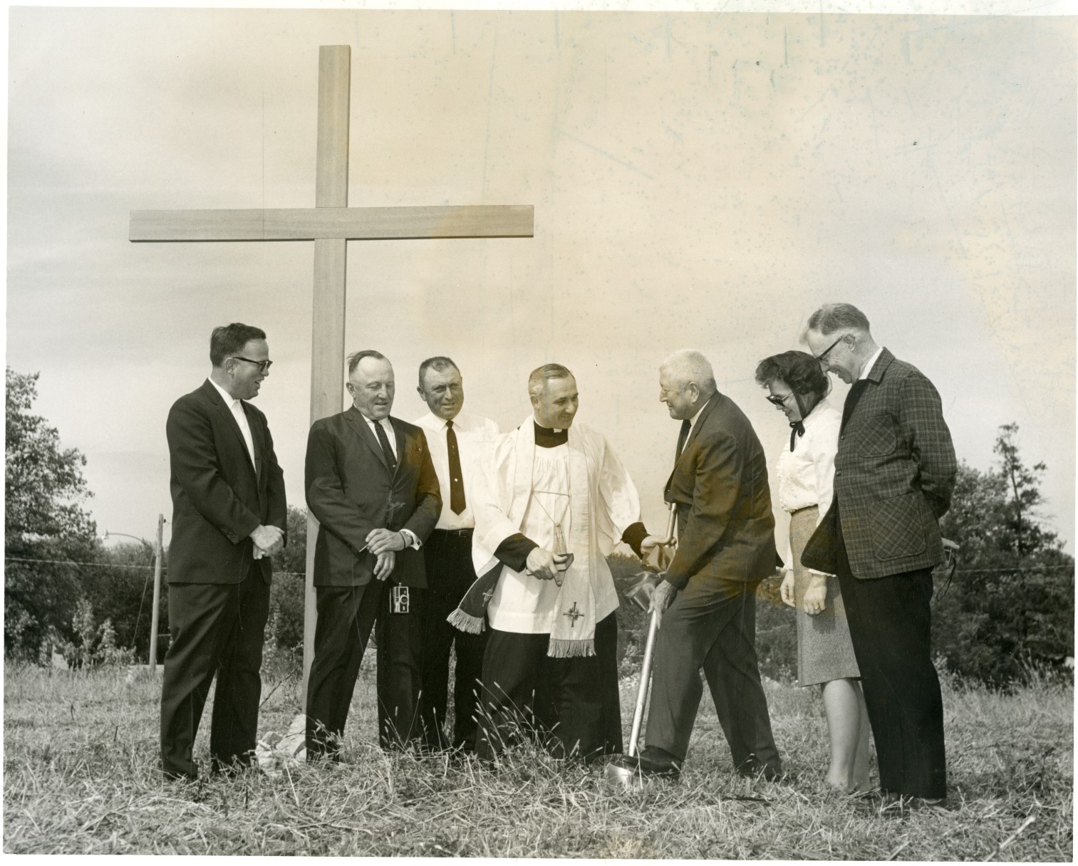 Black and white photo of Dr. Robert Ferring (Pastor) and other members of the St. John’s Building Committee breaking the ground for the new St. John’s Catholic Church.