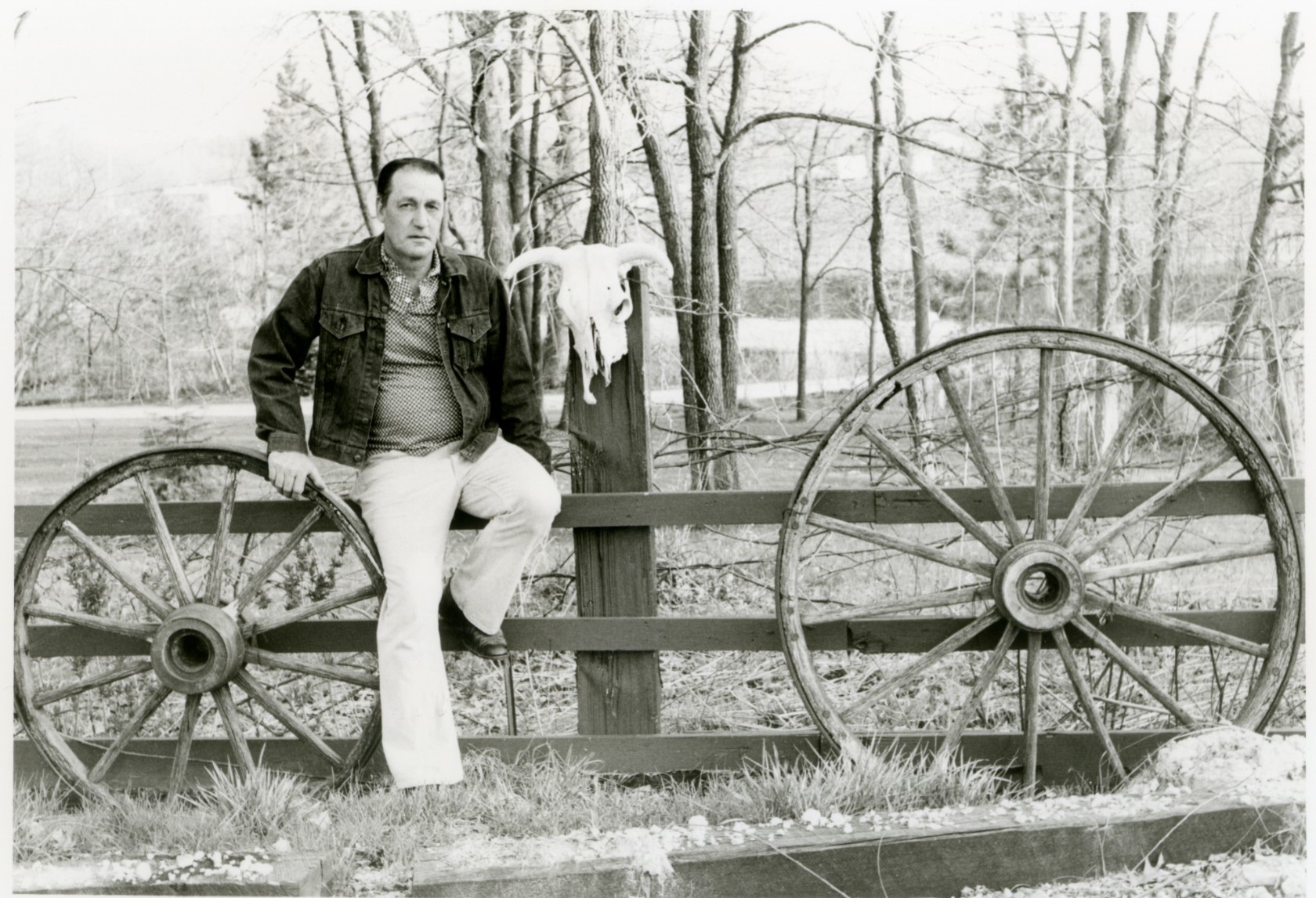 Black and white photo of Ward Viter sitting on a fence.