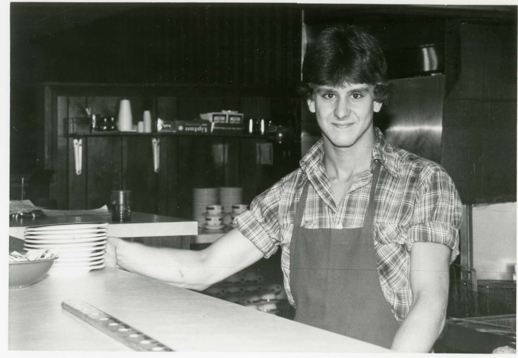 Black and white photo of John Niederhauser working at J-Bo's.
